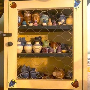 57 assorted Miniature pottery pieces. Cabinet not included